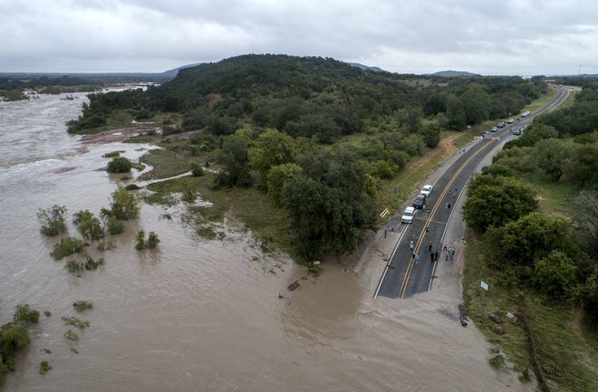 Slab Road in Kingsland is covered with water from the swollen Llano River in Kingsland on Tuesday. [JAY JANNER/AMERICAN-STATESMAN]