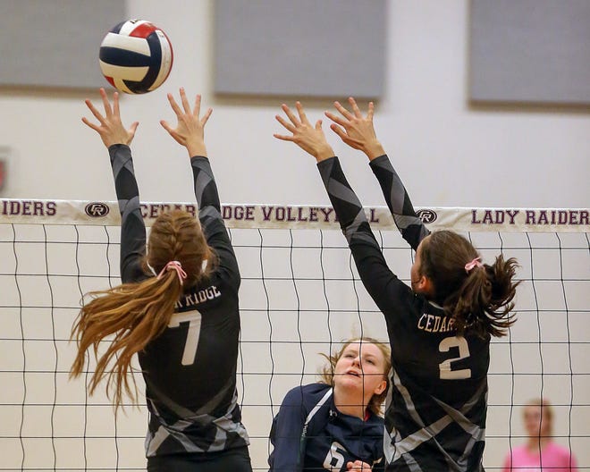 McNeil's Erin Flood (6) spikes the volleyball past Cedar Ridge Raiders defenders Cassie Cox (7) and Lauren Prendeville (2) in the Raiders' gym on Oct. 2. Flood helped McNeil rally for a five-set win over Westwood Friday. [Jamie Harms for AMERICAN-STATESMAN]