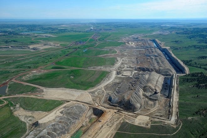 FILE - This file photo taken May 25, 2013, shows an aerial view of Colstrip power plants 1,2,3 & 4 and the Westmoreland coal mines near Colstrip, Mont. Westmoreland Coal Co. of Englewood, Colo., filed for bankruptcy Tuesday, Oct. 9, 2018, to deal with steep debt and declining world demand. Company officials say the Chapter 11 filing is part of a restructuring agreement with an unnamed group of lenders. Company officials say operations won't be interrupted and there are no expected staff reductions. Westmoreland has coal mines in Montana, Wyoming, New Mexico, Ohio, North Dakota and Texas and a coal-fired power plant in North Carolina. (Larry Mayer/The Billings Gazette via AP, File)