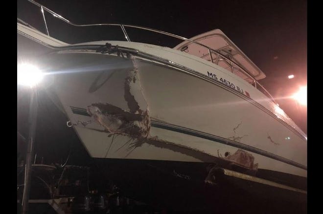 The boat crashed into a buoy, throwing its occupants into the water. [Wareham police photo]
