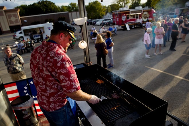 Jason Richardson, owner of Skippers Island Oasis food truck, cooks a customer's order during the Appetite on the Avenue event in the parking lot of Shop 'n Save on North Grand Avenue on Tuesday. [Ted Schurter/The State Journal-Register]