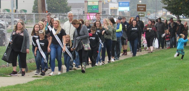 Participants in the 4th Annual Mental Health Walk Sunday (left) take laps at Wethersfield Schools after the event at Windmont was changed because of rainy weather.