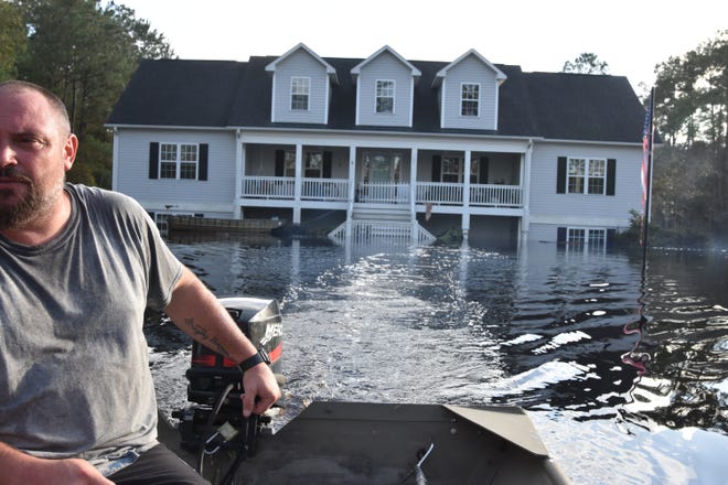 Jason Green gave his friend Kim West a ride to her home on the Black River last month see just how high the water came up in her home after Hurricane Florence. Vibrio bacteria make coming in contact with floodwaters particularly dangerous. [ASHLEY MORRIS/STARNEWS]