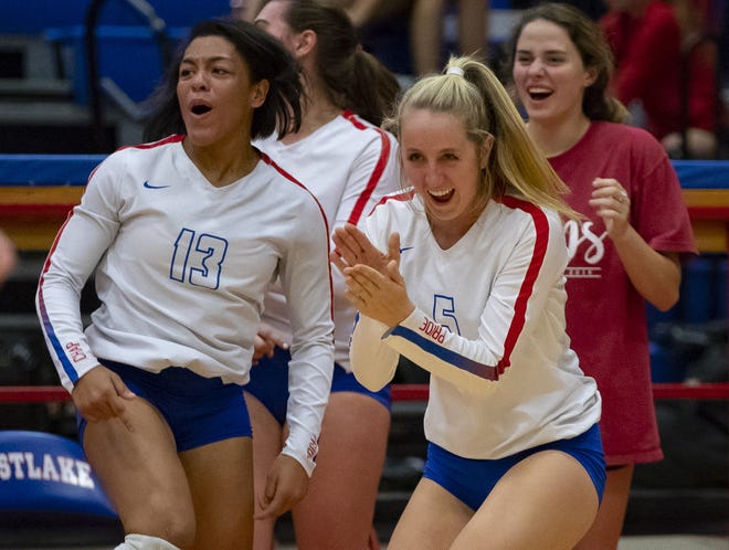 Westlake Chaparrals Maddie Brown (5) and Rylee Baptiste (13) react following the kill score against the Lake Travis Cavaliers during the first set at the District 25-6A volleyball game on Friday at Westlake High School. [JOHN GUTIERREZ / FOR AMERICAN-STATESMAN]