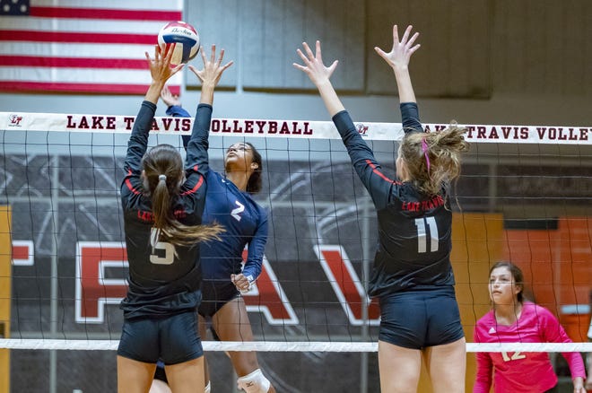 Lake Travis' Kristen Kleymeyer (5) blocks the attempted kill by Hays Rebels Joselyn Roberson (2) during the third set at the District 25-6A volleyball game on Tuesday at Lake Travis High School. [JOHN GUTIERREZ / FOR STATESMAN]