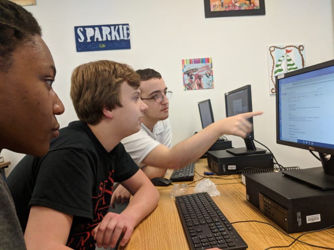 Mathias Gentry, Logan Patterson and Skylar Hawkins prepare for a new virtual challenge as part of the Spartanburg High School CyberPatriots team on Wednesday. [ADAM ORR/SPARTANBURG HERALD-JOURNAL]