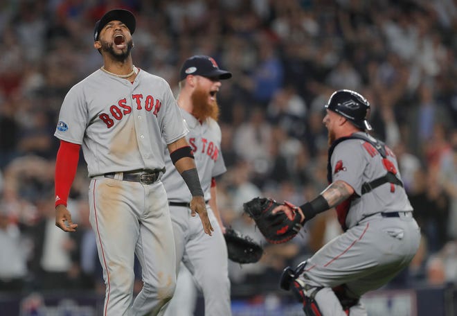 Boston Red Sox third baseman Eduardo Nunez, left, celebrates with relief pitcher Craig Kimbrel, center, and catcher Christian Vazquez after the Red Sox beat the New York Yankees 4-3 in Game 4 of baseball's American League Division Series, Tuesday, Oct. 9, 2018, in New York. (AP Photo/Julie Jacobson)
