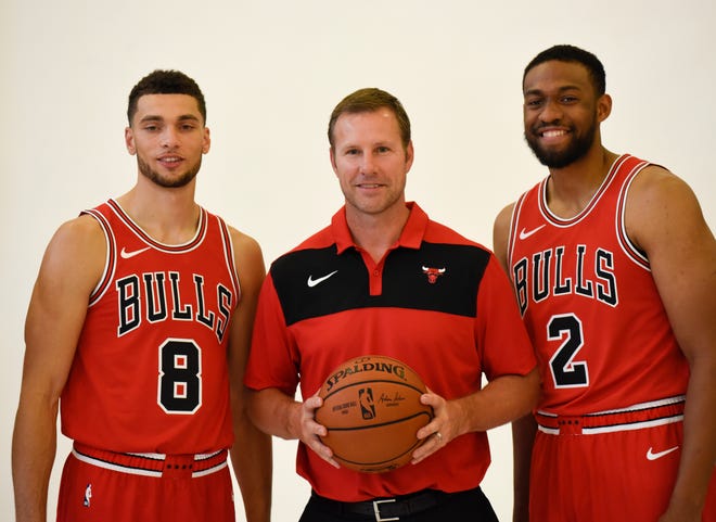 In this Sept. 24, 2018 photo Chicago Bulls' Zach LaVine (8) head coach Fred Hoiberg and Jabari Parker (2) pose for a photo during media day at the NBA basketball team's facility in Chicago. With a core of promising young players, the Chicago Bulls believe they are setting themselves up to make a jump after going 27-55 and missing the playoffs for the second time in three years. They’re banking on Lauri Markkanen building on an impressive rookie season and Zach LaVine showing he really is a cornerstone piece. It wouldn’t hurt, either, if Jabari Parker stayed healthy after signing with his hometown team in the offseason. (AP Photo/David Banks)