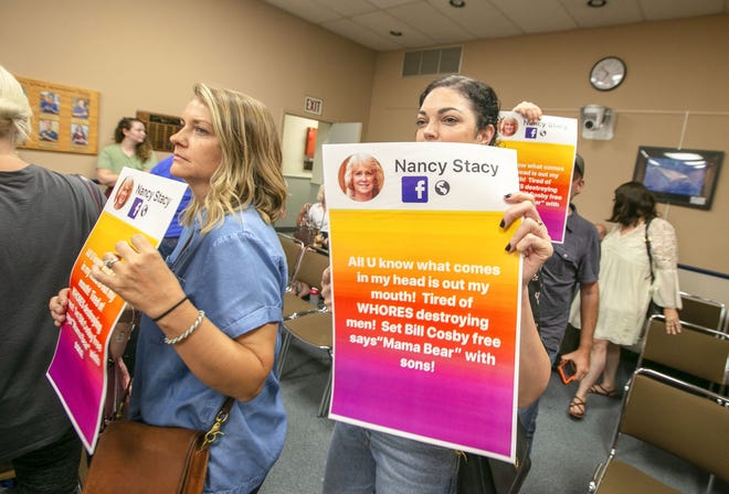 Audience members upset by Marion County School Board member Nancy Stacey's Facebook posts leave the chamber on Tuesday. [Alan Youngblood/Star-Banner]