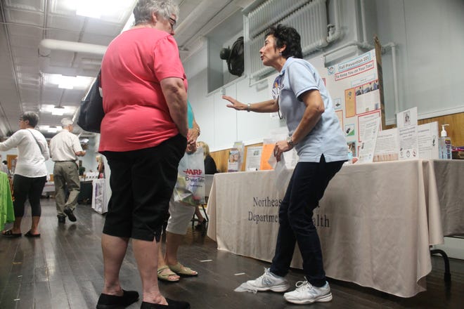 Northeast District Department of Health Education and Communications Coordinator Linda Colangelo shows attendees that something as simple as a stray dryer sheet can cause a catastrophic fall in the home during Putnam's senior information fair Wednesday. [Kerensa Konesni/For The Bulletin]