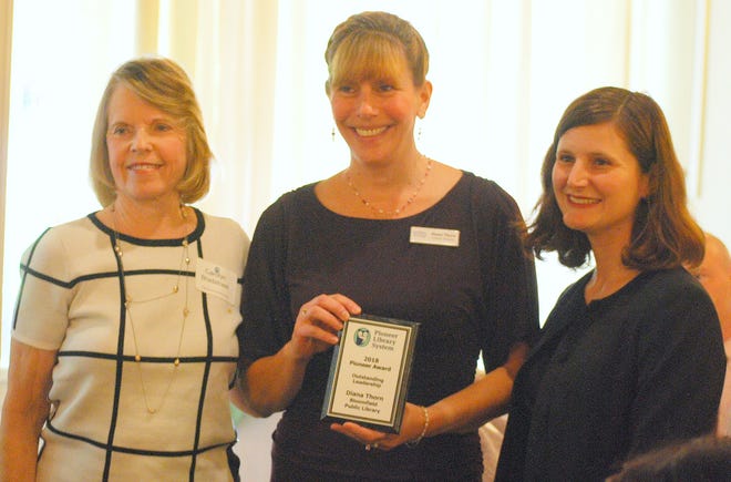 Bloomfield Public Library Director Diana Thorn, center, receives the Pioneer Library System's Leadership Award in Avon. She is pictured with Carolyn Bradstreet, a member of the library system's board, and Lauren Moore, its executive director. [PHOTO PROVIDED]