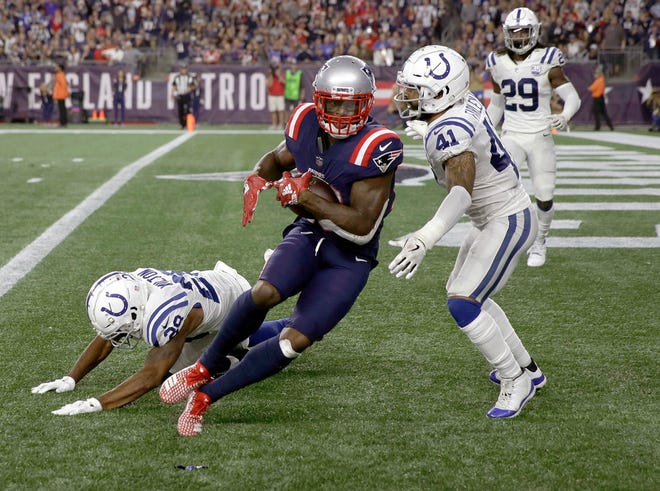 New England Patriots wide receiver Josh Gordon, makes a touchdown catch in front of Indianapolis Colts defensive back Matthias Farley (41) during the second half of an NFL football game, Thursday, Oct. 4, 2018, in Foxborough, Mass.