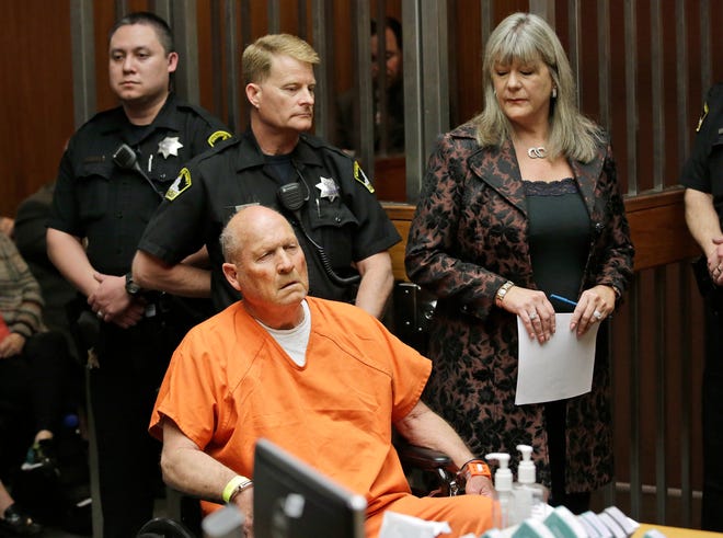 FILE - In this Friday, April 27, 2018 file photo, Joseph James DeAngelo, 72, who authorities suspect is the "Golden State Killer" responsible for at least a dozen murders and 50 rapes in the 1970s and 80s, is accompanied by Sacramento County Public Defender Diane Howard, right, during his arraignment in Sacramento County Superior Court in Sacramento, Calif. Authorities said they used a genetic genealogy website to connect some crime-scene DNA to DeAngelo. (AP Photo/Rich Pedroncelli)