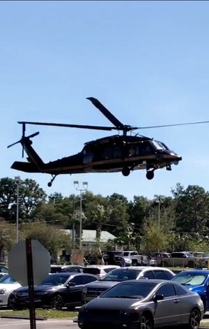 A helicopter lands in the parking lot of White-Wilson Medical Center on Thursday with a patient from the hurricane-ravaged Panama City area being transferred to Fort Walton Beach Medical Center. [ROCHELLE TAYLOR/CONTRIBUTED PHOTO]