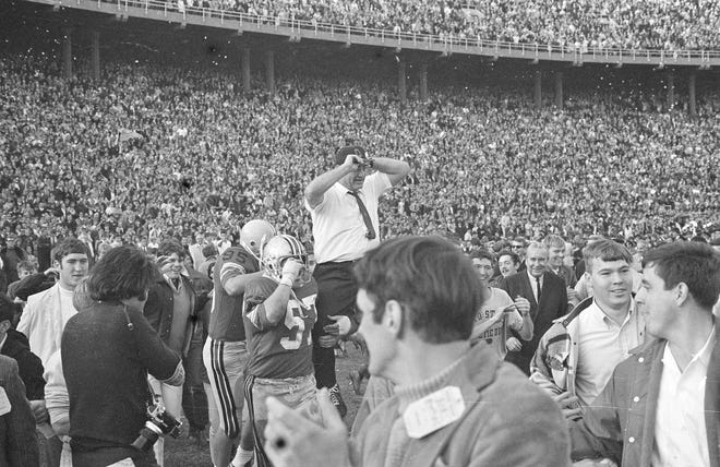 Coach Woody Hayes is carried from the field by jubilant players after Ohio State downed Michigan 50-14 to win the Big Ten championship and a trip to the Rose Bowl, in Columbus, Nov. 23, 1968. (AP Photo)