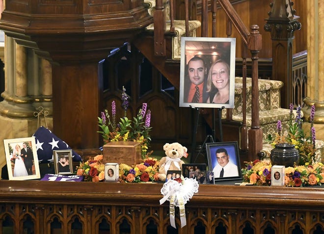 A unity urn with cremated ashes of Robert Joseph Dyson and Mary E. Dyson is set in place as friends and family prepare for a funeral mass Saturday at St. Stanislaus Roman Catholic Church in Amsterdam, N.Y., for eight of the 20 people killed in the fatal limousine crash Oct. 6 in Schoharie, N.Y. [HANS PENNINK/ASSOCIATED PRESS]