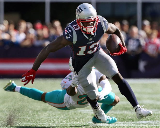 Patriots receiver Phillip Dorsett gains yards after a catch as he escapes the grasp of Miami's Torry McTyer in their Sept. 30 game in Foxboro.