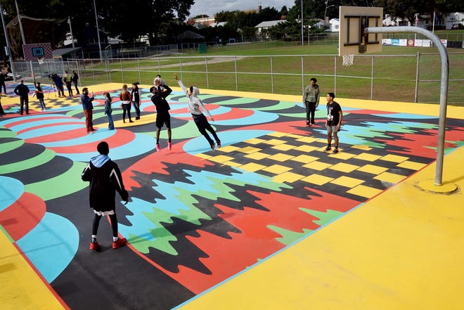 The two basketball courts at Providence's Fargnoli Park are a crazy quilt of vibrant colors and interlocking shapes designed by acclaimed artist Jim Drain.  [The Providence Journal / Kris Craig]