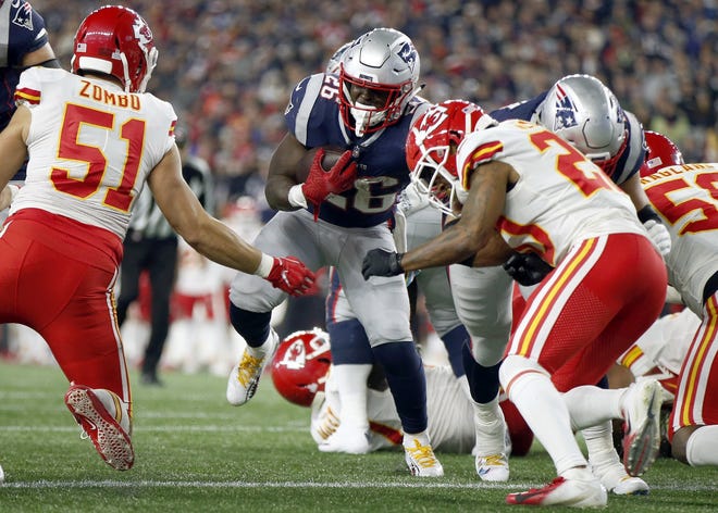 New England running back Sony Michel scores a touchdown against the Kansas City Chiefs during the first half of Sunday's game. [The Associated Press]
