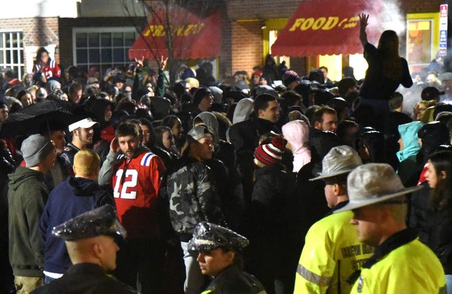 Crowds gathered on Main Street in Durham following Sunday night's Super Bowl and University of New Hampshire, Durham and state police worked to disperse the group following the New England Patriots' loss to the Philadelphia Eagles. [Deb Cram/Fosters.com]