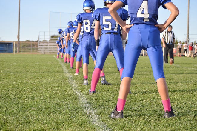 The Pittsford junior varsity football team stands at attention before the game. [SAM FRY PHOTO]