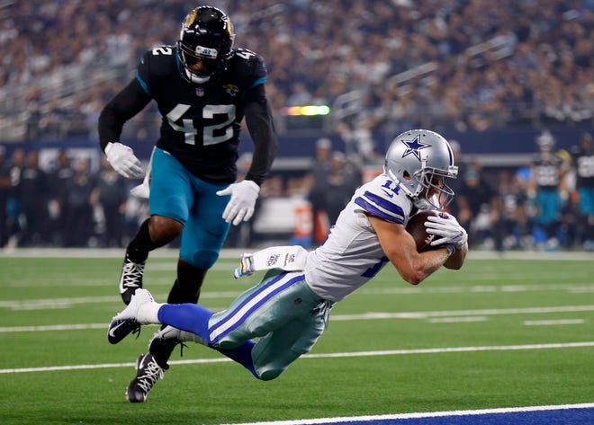 Dallas wide receiver Cole Beasley (11) dives into the end zone in front of Jacksonville strong safety Barry Church (42) for a touchdown during the Cowboys' 40-7 win Sunday. Beasley got the first 100-yard game for a Dallas wideout this season (101) while tying career highs with nine catches and two touchdowns. [AP Photo/Ron Jenkins]