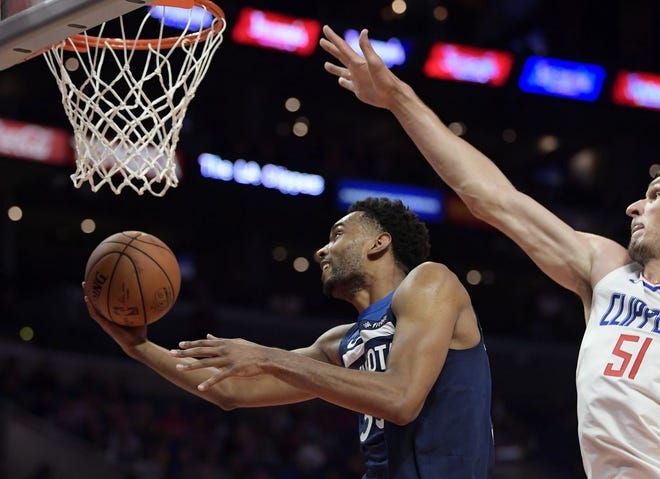Minnesota Timberwolves forward Keita Bates-Diop, left, shoots as Los Angeles Clippers center Boban Marjanovic defends during the second half of an NBA preseason basketball game Wednesday, Oct. 3, 2018, in Los Angeles. (AP Photo/Mark J. Terrill)