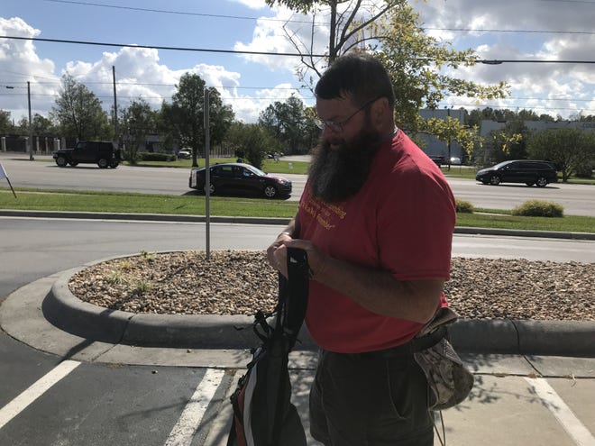Marine Corps veteran Doc Doolittle prepares his pack for a 12-mile walk Monday morning in Jacksonville. Doolittle plans to complete 273 miles in time for the Beruit bombing anniversary Oct. 23. [Kelsey Stiglitz/The Daily News]