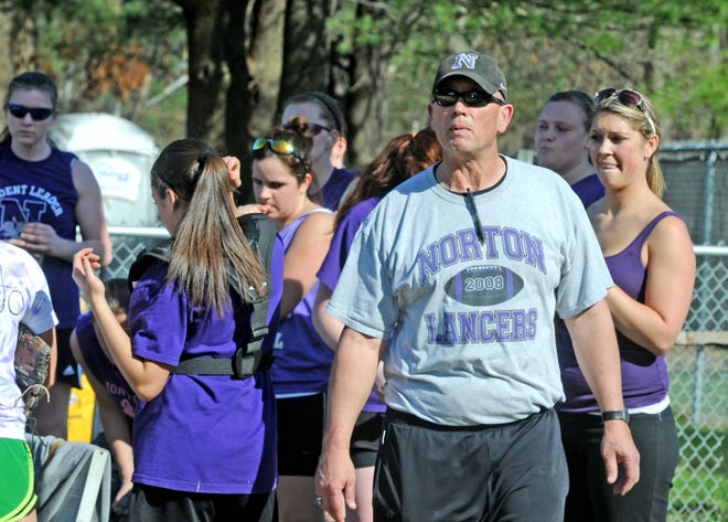 Norton softball head coach Brian Clemmey heads out to the field after talking to his players during a 2012 scrimmage game. Clemmey collapsed on the football field while refereeing last Friday's game between Whitman-Hanson and Silver Lake.