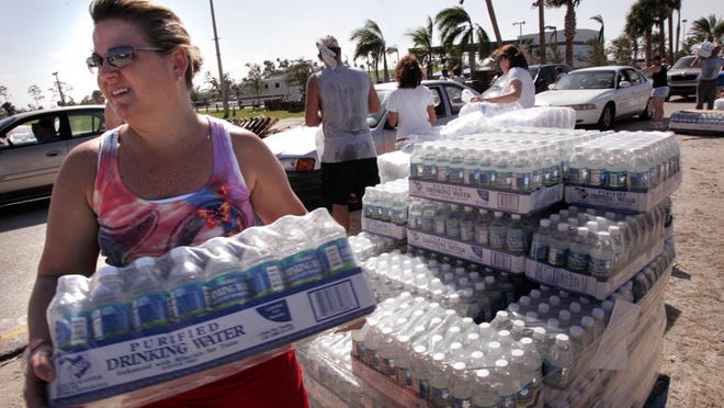 Volunteer Cheryl Soley of Lake Worth helps load water and ice at the distribution center at the South Florida Fairgrounds after 2004's Hurricane Jeanne. Soley, who wanted to help after Hurricane Frances decide to take vacation time from work to be a volunteer after Hurricane Jeanne.