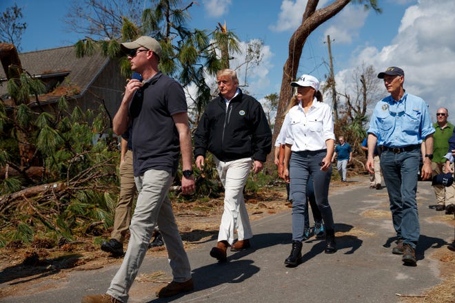 President Donald Trump and first lady Melania Trump tour a neighborhood affected by Hurricane Michael, Monday, in Lynn Haven, Fla. Florida Gov. Rick Scott is right. [EVAN VUCCI/THE ASSOCIATED PRESS]