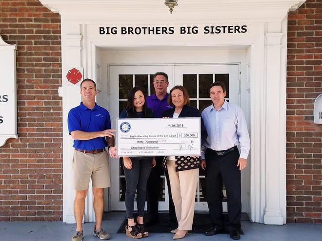 John Giglio, president and CEO of the Freedom Boat Club, and Chelsea Smith, special events and marketing coordinator, present a $30,000 check to Big Brothers Big Sisters of the Sun Coast. They are joined by Joy Mahler, president and CEO of Big Brothers Big Sisters of the Sun Coast; Mark Ferster, vice president of Operations Big Brothers Big Sisters of the Sun Coast; and Ira Paul, vice president of Community Development Big Brothers Big Sisters of the Sun Coast. [COURTESY PHOTO]