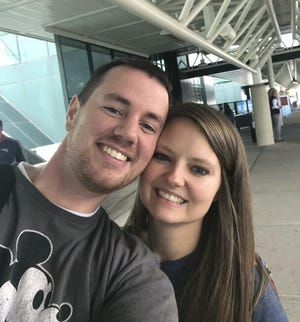 In this selfie provided by Clark and Heather Ensminger, Clark Ensminger, left, poses with his wife, Heather, in Nashville, Tenn., marking the cross-country trip they are taking to see every U.S. Disney park in a single day. [Courtesy of Clark and Heather Ensminger via AP]