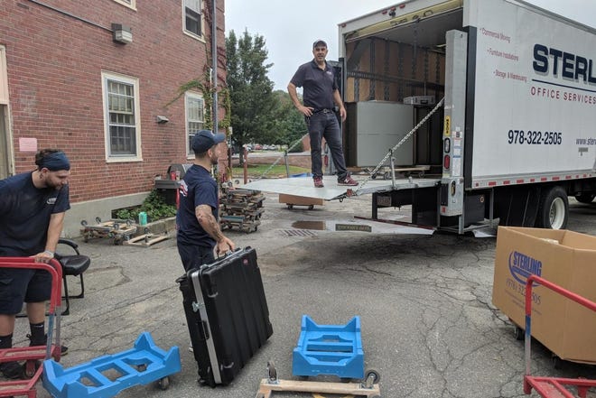 Movers load a box truck with Lexington Fire Department equipment behind the department's old headquarters in the summer of 2018. [Courtesy Photo / Town of Lexington]