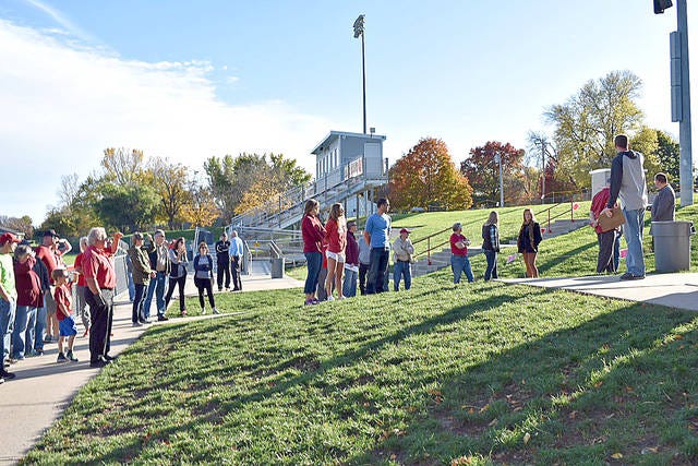 Several local residents tour Roland-Story’s high school track and football field in October 2017. The facility is on the school district’s five-year facilities improvement plan. Photo by Ronna Lawless