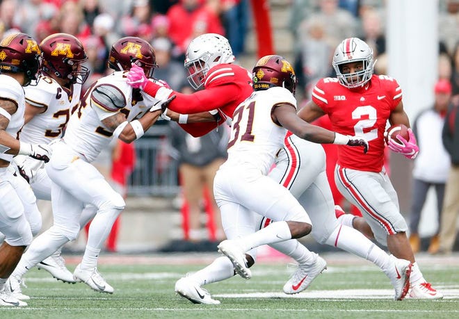 Ohio State Buckeyes running back J.K. Dobbins (2) waits for space to open up on a run against Minnesota Golden Gophers in the 1st quarter of their game at Ohio Stadium on Saturday. [Kyle Robertson]
