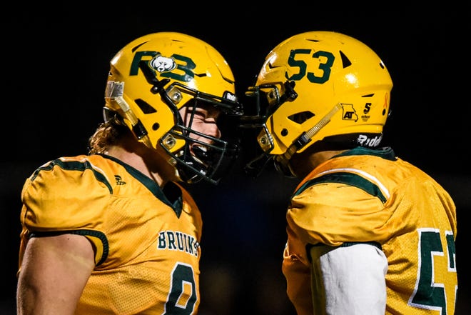 Rock Bridge tight end/linebacker Will Norris (8) and Rock Bridge linebacker/lineman Melvin Drayton (53) celebrate a tackle during a game at Rock Bridge High School on Friday, October 12, 2018. [Hunter Dyke/Tribune]