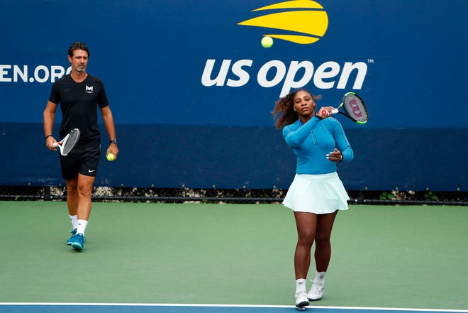 FILE - In this Aug. 31, 2018, file photo, Serena Williams walks on a practice court with her coach, Patrick Mouratoglou, during the third round of the U.S. Open tennis tournament, in New York. Serena Williams' coach says in-match coaching should be allowed in tennis to help the sport's popularity. Mouratoglou, who admitted he used banned hand signals to try to help Williams during her loss in the U.S. Open final, wrote Thursday, Oct. 18, 2018, in a posting on Twitter that legalizing coaching and making it part of the spectacle would let "viewers enjoy it as a show."(AP Photo/Adam Hunger, File)