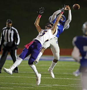 Estacado's TJ Steele (5) tries to intercept the ball around Dalhart's Trey Campbell (25) during a District 2-4A Division II game Thursday at PlainsCapital Park at Lowrey Field. The Matadors collected three interceptions in the second half. [Brad Tollefson/A-J Media]