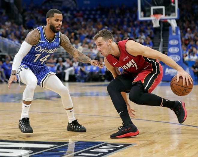 Miami Heat's Goran Dragic, right, looks for a way past Orlando Magic's D.J. Augustin (14) during the first half of an NBA basketball game, Wednesday, Oct. 17, 2018, in Orlando, Fla. (AP Photo/John Raoux)