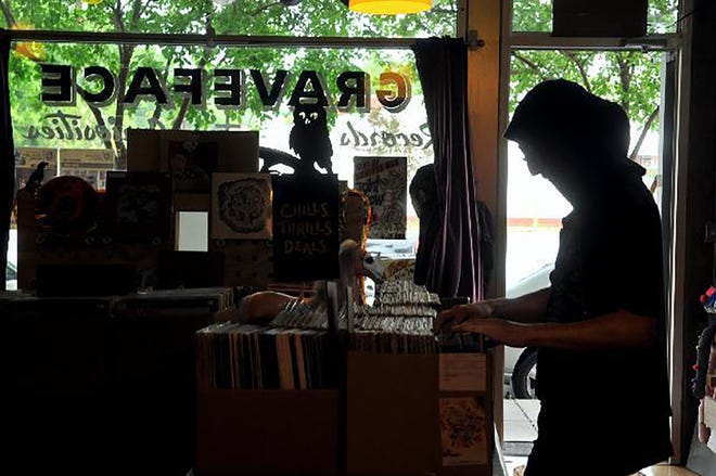 Ryan Graveface sorts records at his store. [File photo]