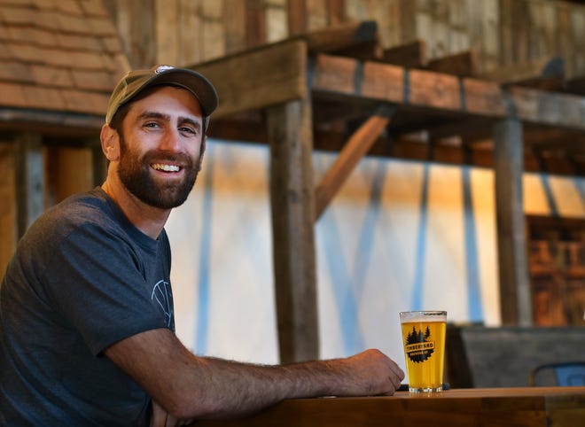 Co-owner Matt Zarif sits at the bar of Timberyard Brewing Co., which opens Friday in East Brookfield. After transforming the former Howe Lumber location into a taproom and brewery, co-owners Mr. Zarif and his wife, Nellie, and TJ O'Connor and Tom Sutter are ready for the grand opening. [T&G Staff/Christine Peterson]