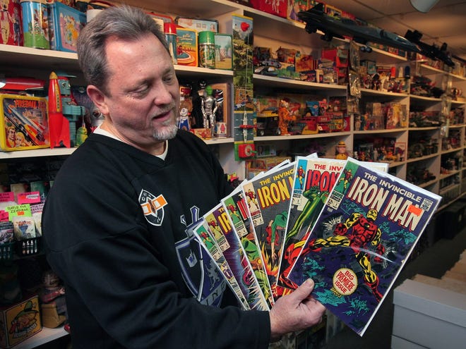Daniel Hare, owner of the vintage toy store, The Toys Time Forgot, holds the first six issues of The Invincible Iron Man that are from a large private collection of 14,000 Marvel/DC comics the store found in Salem, Ohio. The comic books in this Jan. 27, 2016, photo were later auctioned. (Ed Suba Jr./Akron Beacon Journal)
