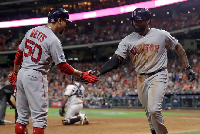 Boston Red Sox's Jackie Bradley Jr., celebrates after his two-run home run with Mookie Betts against the Houston Astros during the sixth inning in Game 4 of a baseball American League Championship Series on Wednesday, Oct. 17, 2018, in Houston. (AP Photo/Frank Franklin II)