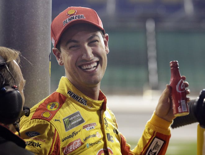 NASCAR Cup Series driver Joey Logano celebrates after winning the pole following qualifying for this weekend's auto race at Kansas Speedway. [AP PHOTO/ORLIN WAGNER]
