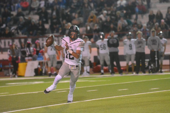 Randall quarterback Jakobe Norman looks to pass in Friday night's game at Plainview. Randall beat Plainview 31-8 to improve to 2-0 in District 3-5A Division II and can make the playoffs with another win. [Alexis Cubit/For the Globe-News]