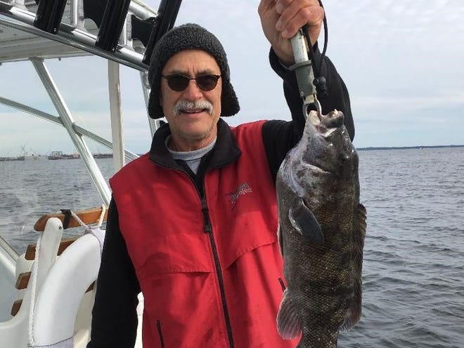 Kevin Fetzer of East Greenwich with a 22-inch tautog he caught at General Rock, North Kingstown last week.