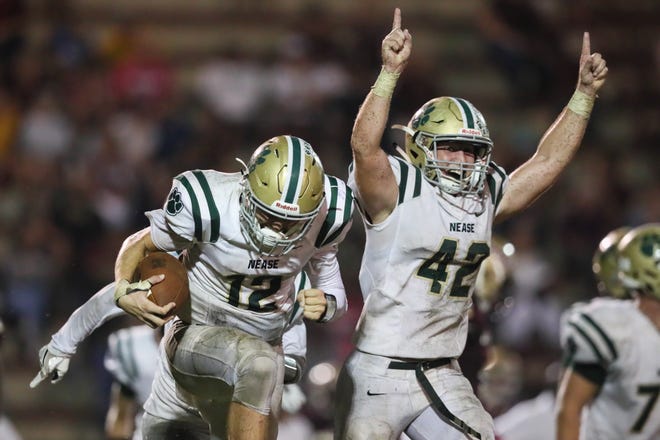 Nease's Stephen Sarama (42) and Preston Staples (12) celebrate the Panthers' 14-13 victory over St. Augustine on Friday night. [James Gilbert/Correspondent]