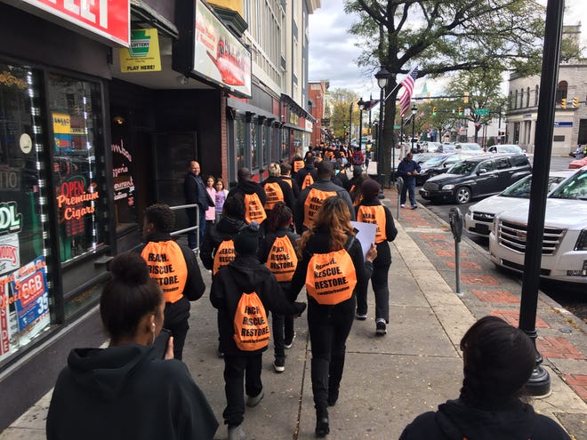 Wearing orange “swag bags” saying “Reach, Rescue, Restore,” participants joined the Saturday, Oct. 20, 2018 Walk For Freedom in Stroudsburg Borough, organized by A21 and Community Church of Tobyhanna to protest human trafficking. [ANDREW SCOTT/POCONO RECORD]