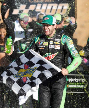 Chase Elliott celebrates his win at Kansas Speedway on Sunday. [Colin E. Braley/The Associated Press]